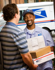 Postal Carrier picking up packages from customer.