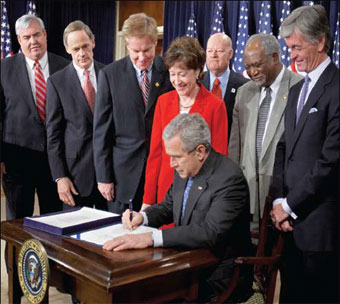 President Bush signing new Postal law.