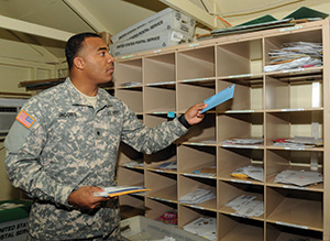 Specialist Brock Jacobs sorts mail at the Camp America Post Office at  Guantanamo Bay, Cuba.