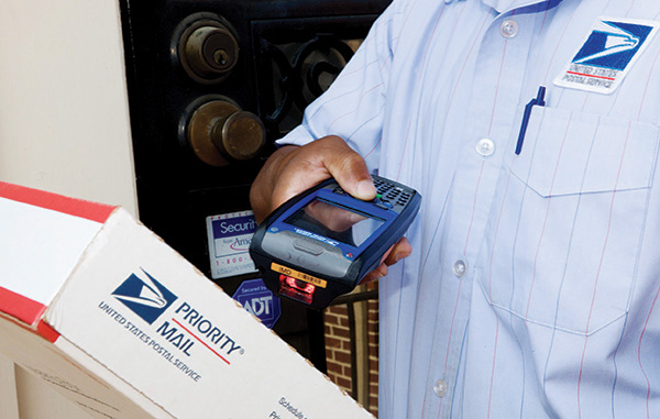 Image of a carrier scanning a Priority Mail box.