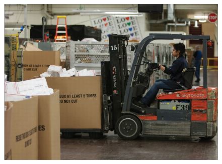 image of a forklift being operated in a wearhouse