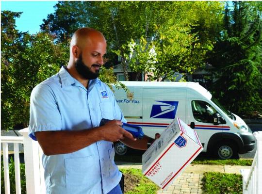 United States Postal Service FY2016 Annual Report to Congress - Front Cover. Carrier scanning a priority mail package.