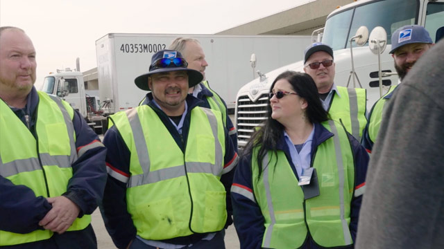 USPS Tractor Trailer Operators meeting outside before they start their routes.