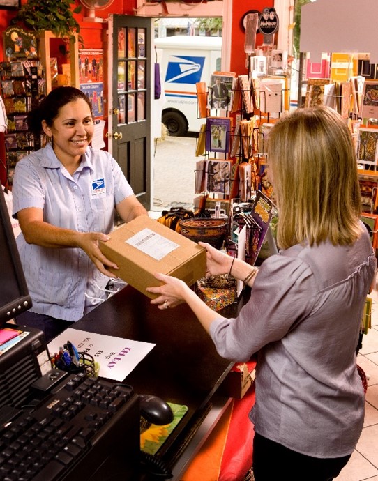 letter carrier delivering packages to a business