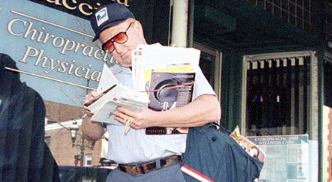 USPS Mail carrier delivering mail.