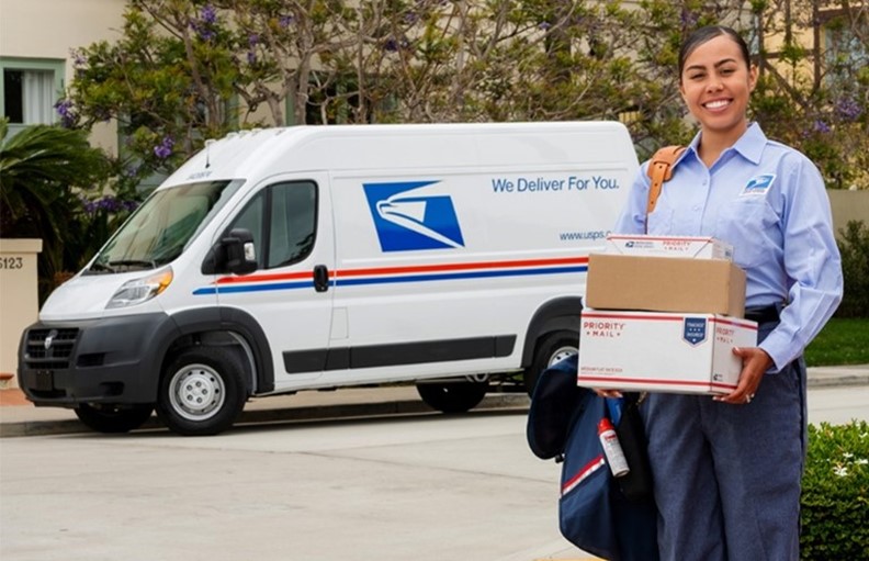 USPS Letter Carrier holding packages