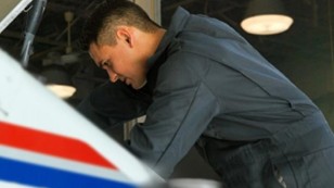 USPS Auto Technician working on a vehicle