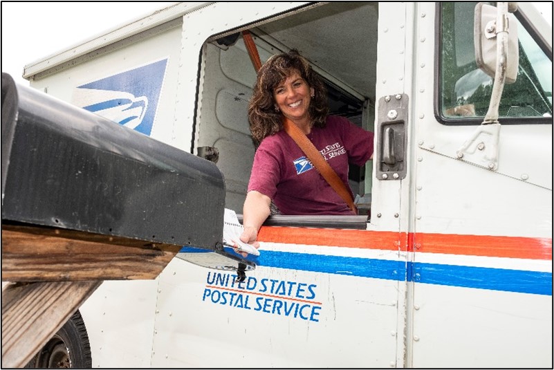Rural Carrier in a mail truck delivering mail