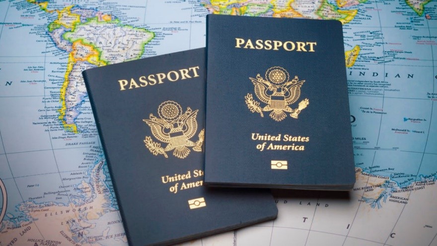Two US Passport books on top of a world map.