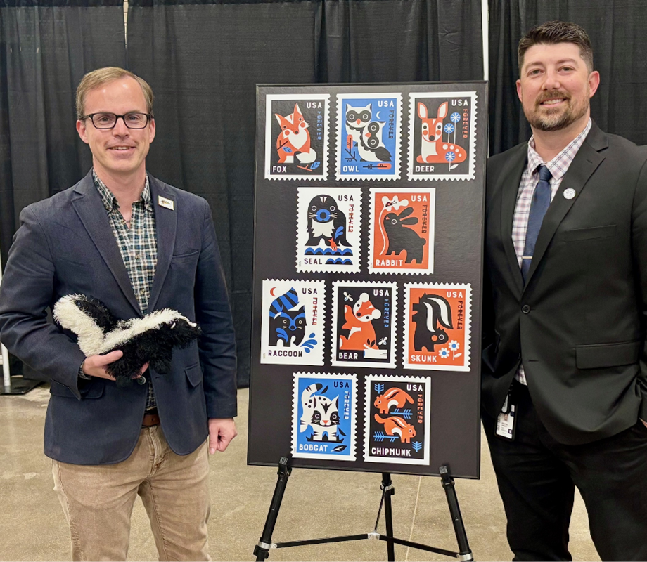 Editor-in-Chief, Linn’s Stamp News Jay Bigalke and Denver Postmaster Spencer Gibson unveil the Postal Services newest stamp