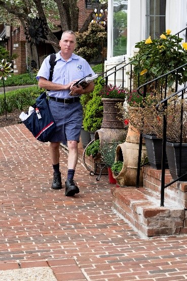 Mail carrier delivering mail