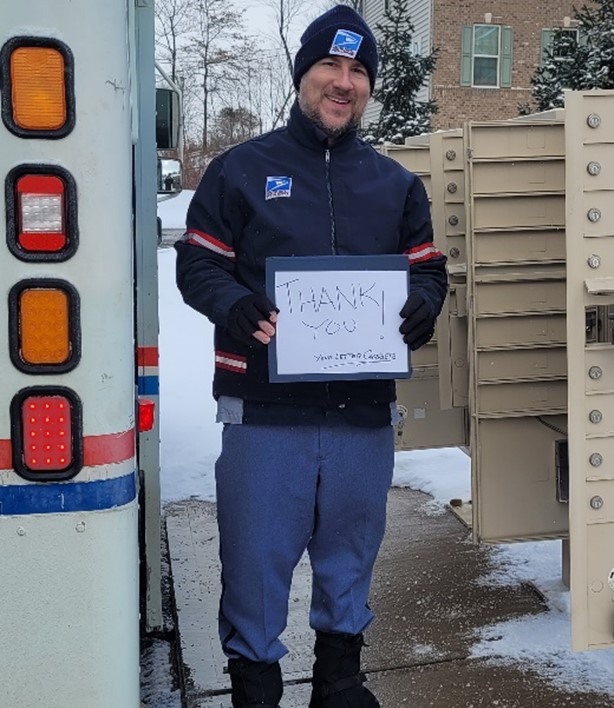 USPS Carrier holding sign