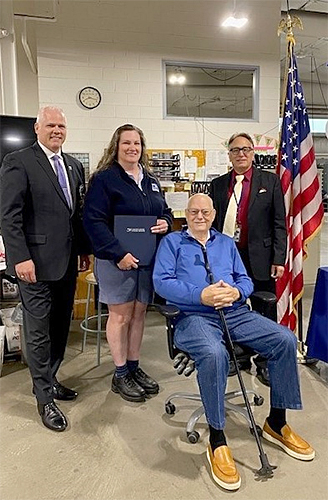 At the Grand Rapids, MI Post Office from left, District Manager Don Dombrow, Jr., Michigan 2 District, Letter Carrier Wilma Daley, Postmaster William Rowe, and seated is Kentwood, MI retired Police Officer Robert Streeter.