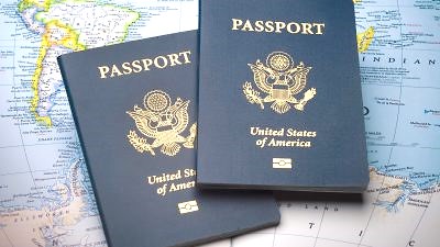Two passport books on a world map