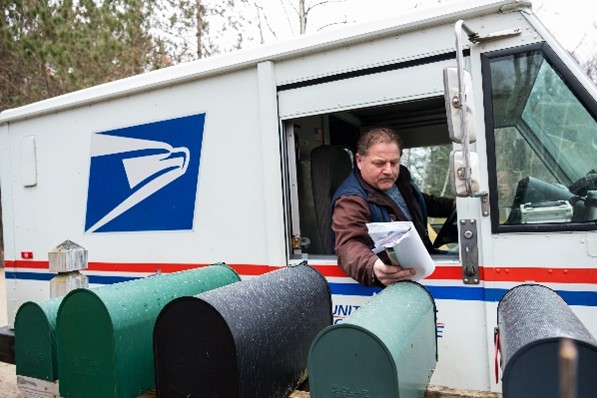 Rural Carrier delivering mail