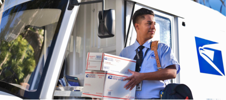 Postal carrier holding packages