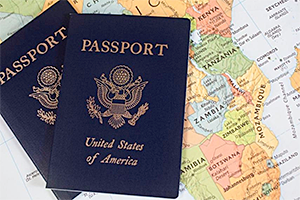 Two US Passport books on top of a world map