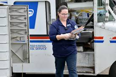 Rural Carrier in front of mailbox cluster