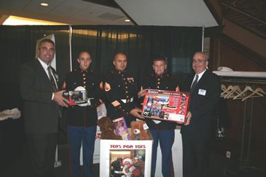PCC Co-Chairs Scott Concannon (l) and Tom Callahan (r) present toys for the US Marine Corps Reserves’ Toys for Tots Campaign.