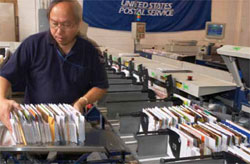 Employee loading mail into sorter