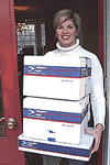 Woman holding boxes.