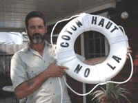 Kenner, 
            LA, Letter Carrier Mike Miller holds the life preserver from his houseboat.