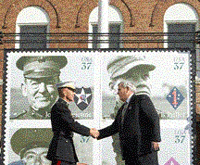 photograph of postmaster general jack potter shaing hand with commandant of the marine corps general Michael W Hagee