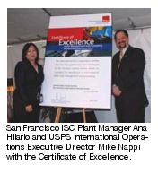 San Francisco ISC Plant Manager Ana Hilario and USPS International Operations Executive Director Mike Nappi with the Certificate of Excellence.