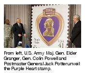 From left, U.S. Army Maj. Gen. Elder Granger, Gen. Colin Powell and Postmaster General Jack Potter unveil the Purple Heart stamp.