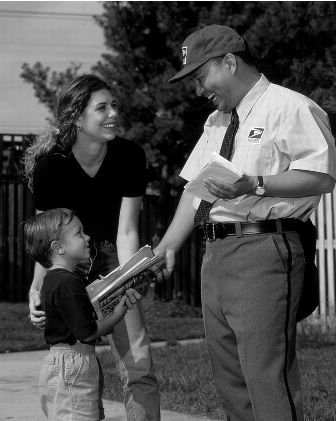 image of postal carrier handing mail to a young boy accompanied by an adult