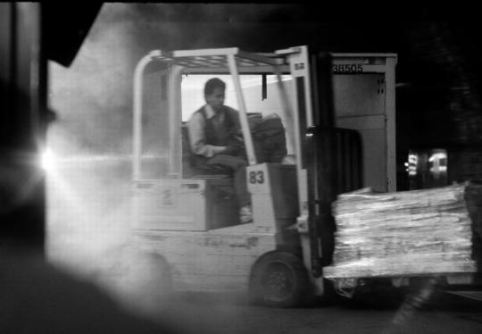 image of postal working using a forklift