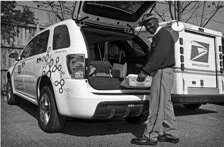 image of postal employee delivering froma fuel cell vehicle