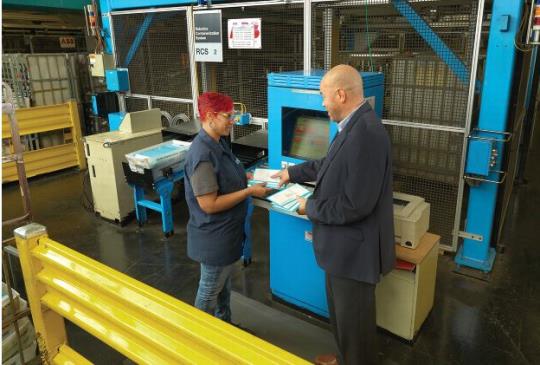 Employees discussing mail processing.