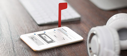Una imagen de marketing de un teléfono inteligente con una bandera de buzón roja.
