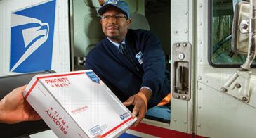 Postal carrier and customer with priority mail package.