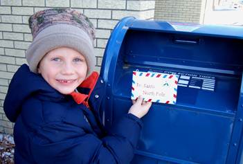 Photograph of child mailing letter to Santa Claus in 2007