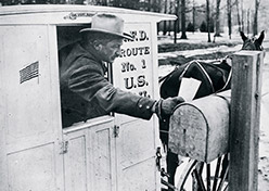 Rural carrier delivering mail